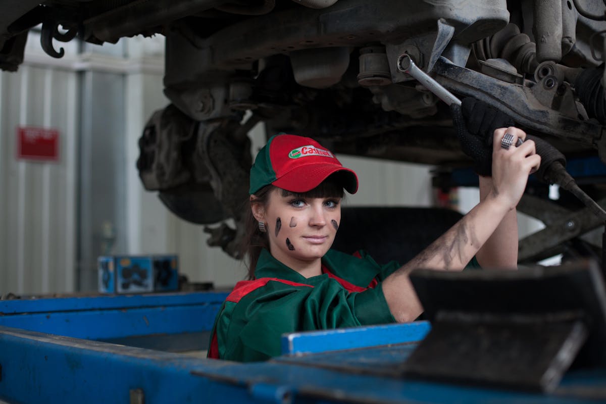 Mechanic working on vehicle steering and suspension components